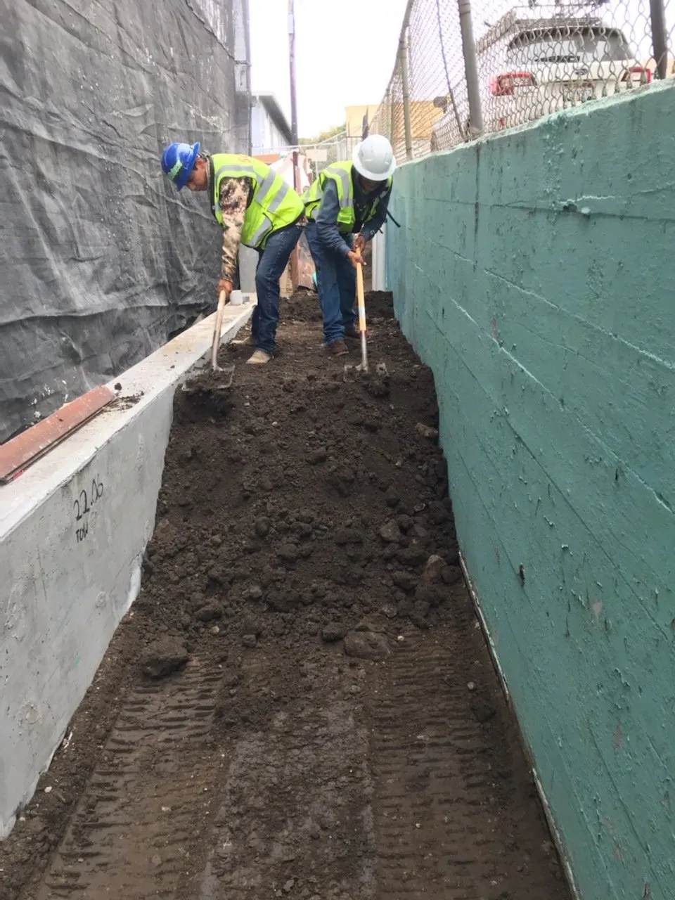 SCUP backfilling dirt in a tight, confined work area