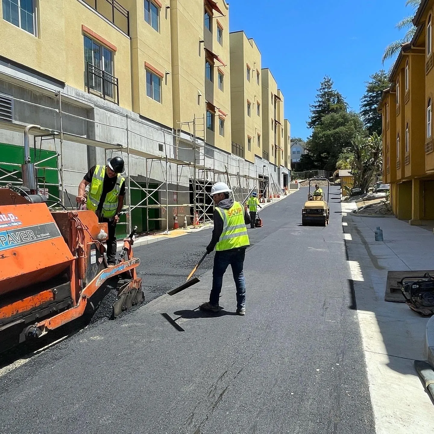 SCUP crew paving a residential street with an asphalt paver and roller
